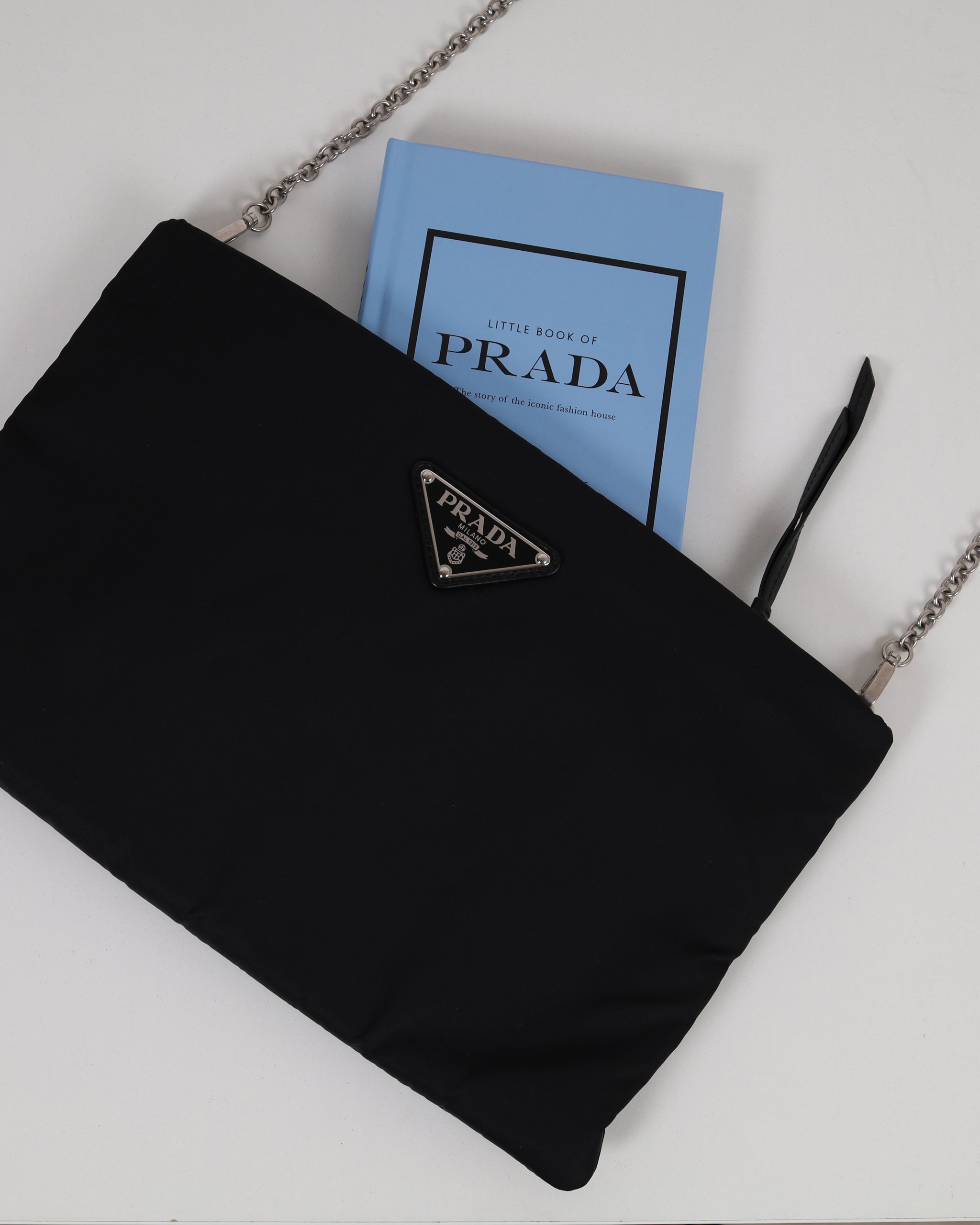 Prada Pouch bag in black with a Prada collections book inside